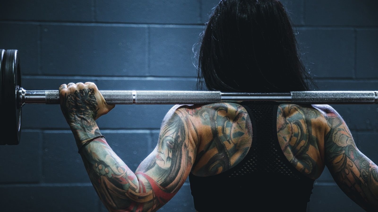 Coach spotting a member through a heavy bench press set